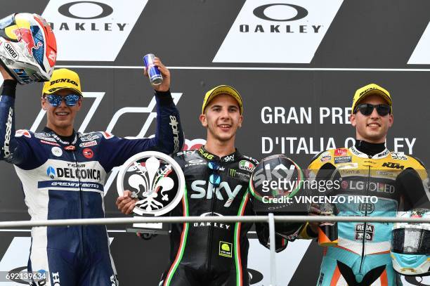 Sky Racing Team VR46 rider Italian Andrea Migno poses on the podium with Del Conca Gresini rider, Italian Fabio Di Giannantonio , second, and RBA BOE...