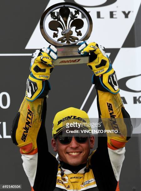 Racing Team rider Spanish Juanfran Guevara, third, celebrates on the podium after winning the Moto 3 Grand Prix at the Mugello race track on June 4,...