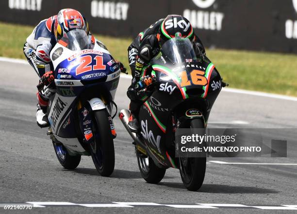 Sky Racing Team VR46 rider Italian Andrea Migno competes with Del Conca Gresini rider, Italian Fabio Di Giannantonio during the Moto3 Grand Prix at...