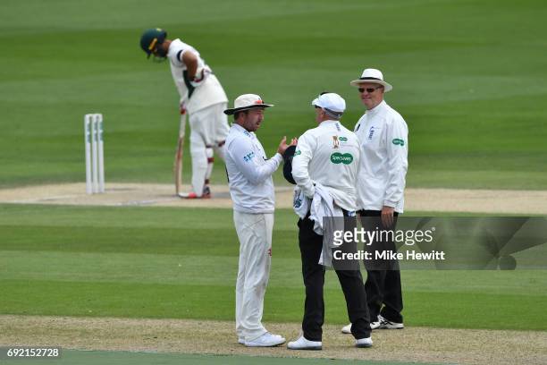 Sussex captain Chris Adams remonstrates with umpires Neil Mallender and Steve Garratt after an lbw decision against batsman Brett D'Oliveira of...
