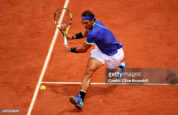 Rafael Nadal of Spain comes to the net to stretch for a plays a backhand during the mens singles fourth round match against Roberto Bautista Agut of...