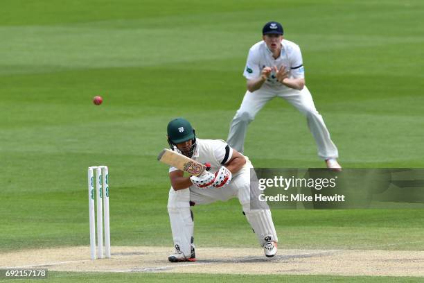 Brett D'Oliveira of Worcestershire ducks under a Chris Jordan bouncer as Luke Wells of Sussex looks on during the third day of the Specsavers County...