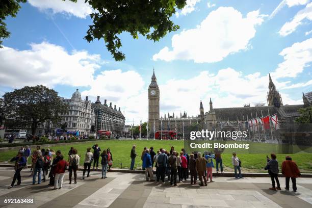 Tourists gather in Parliament Square, in view of the Elizabeth Tower, also known as Big Ben, the day after a terror attack in London, U.K., on...