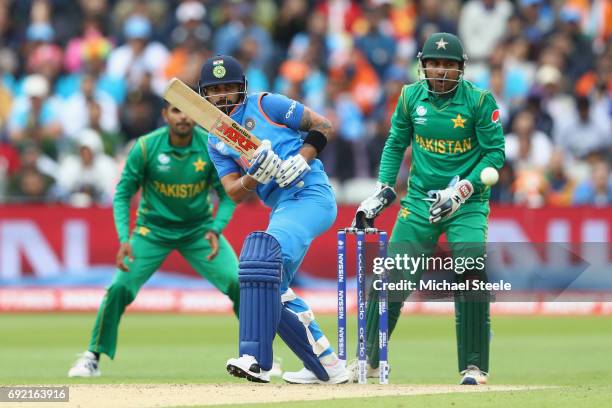 Virat Kohli of India plays to the offside as Pakistan wicketkeeper Sarfraz Ahmed looks on during the ICC Champions Trophy match between India and...