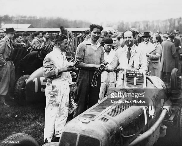 Raymond Mays of Great Britain and driver of the ERA C-Type is congratulated by third placed Peter Whitehead and second placed Percival Maclure after...