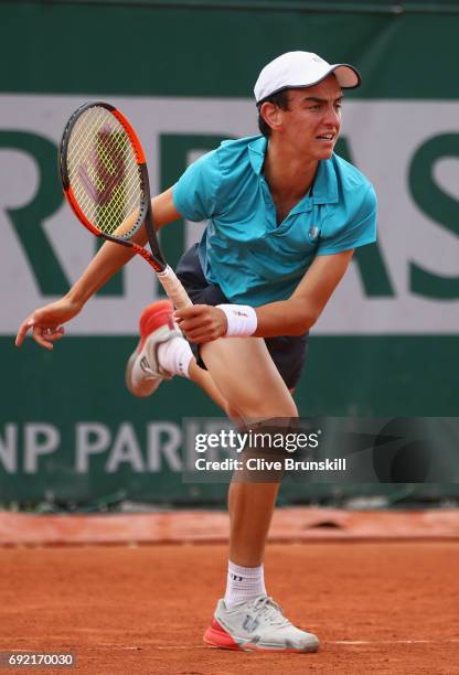 Juan Pablo Grassi Mazzuchi of Argentina serves during the boys singles first round match against Matteo Martineau of France on day eight of the 2017...