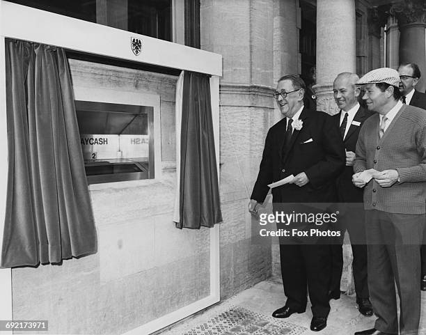 Sir Thomas Bland, Deputy Chairman of Barclays Bank, unveils the first Barclaycash machine in the London borough of Enfield, UK, 27th June 1967....