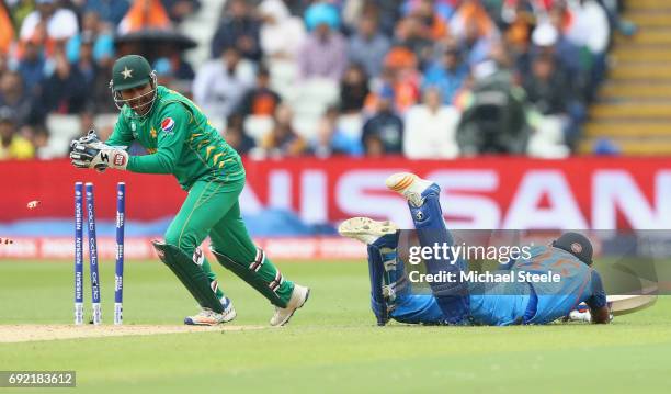 Sarfraz Ahmed of Pakistan removes the bails to run out Rohit Sharma of India during the ICC Champions Trophy match between India and Pakistan at...