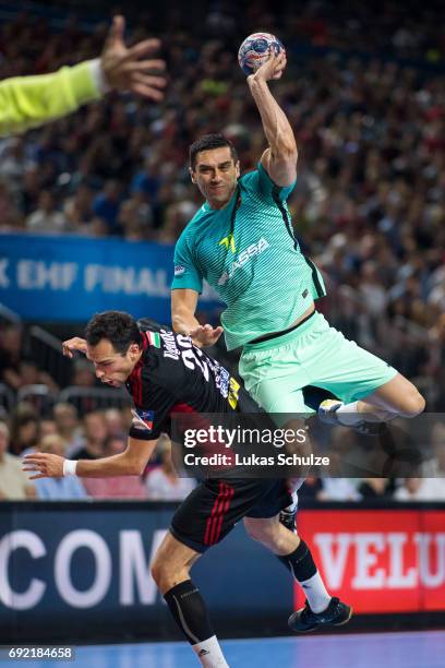 Kiril Lazarov of Barcelona is attacked by Cristian Ugalde of Veszprem during the VELUX EHF FINAL4 3rd place match between Telekom Veszprem and FC...