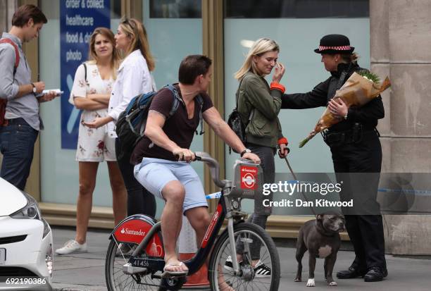 Woman wipes her eye as she speaks to a female police officer near to the scene of last night's terror attack on June 4, 2017 in London, England....