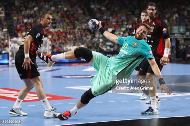 Kamil Syprzak of Barcelona eludes Momir Ilic and Laszlo Nagy of Veszprem during the VELUX EHF FINAL4 3rd place match between Telekom Veszprem and FC...