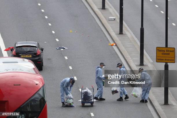 Forensic officers work at the scene on London Bridge following last night's terrorist attack on June 4, 2017 in London, England. Police continue to...