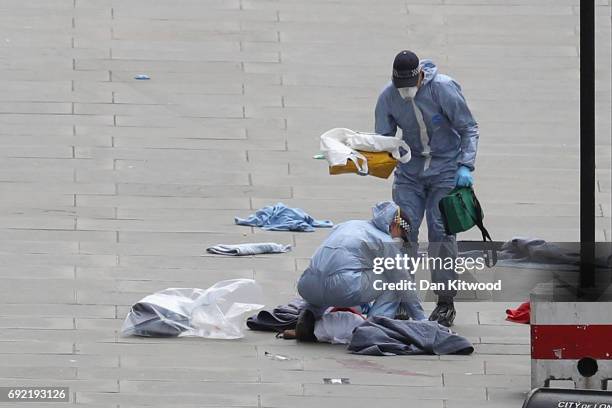 Forensic officers work at the scene on London Bridge following last night's terrorist attack on June 4, 2017 in London, England. Police continue to...