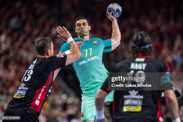 Kiril Lazarov of Barcelona is attacked by Momir Ilic of Veszprem during the VELUX EHF FINAL4 3rd place match between Telekom Veszprem and FC...