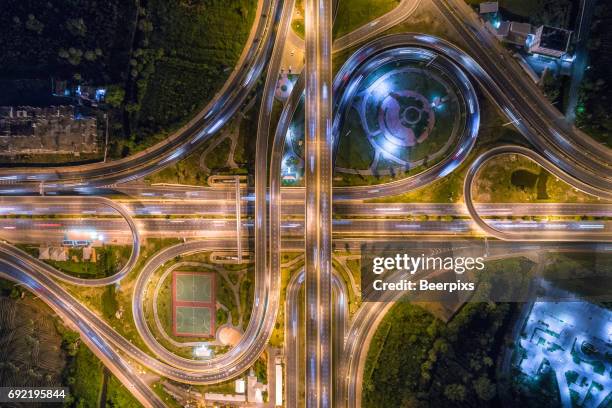 aerial view of infinity road intersection at night. - circular business district stock-fotos und bilder