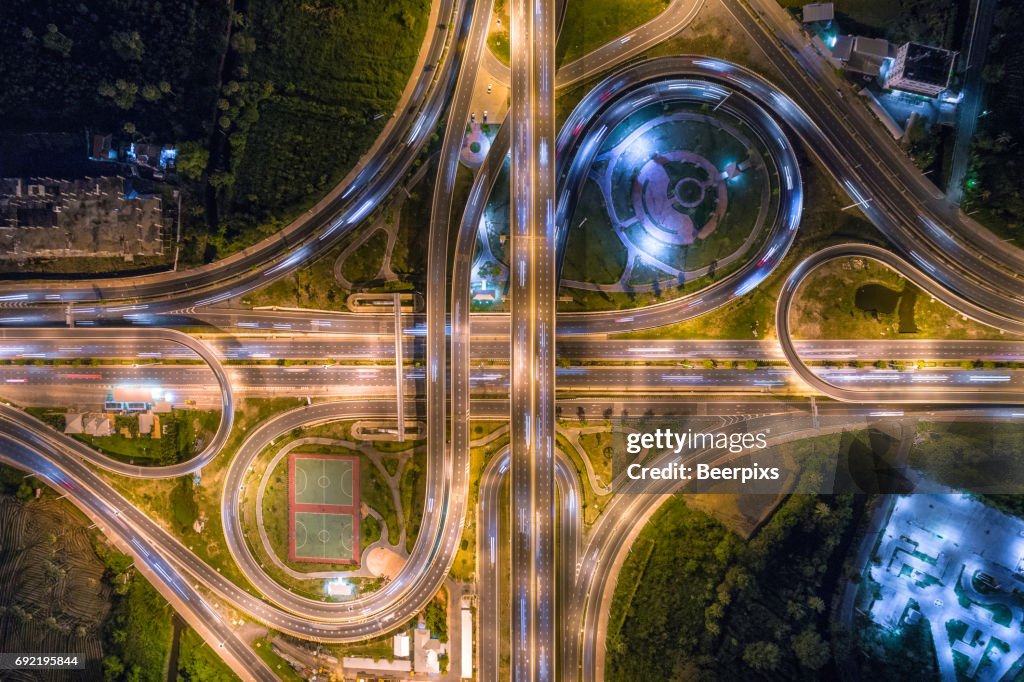 Aerial view of infinity road intersection at night.