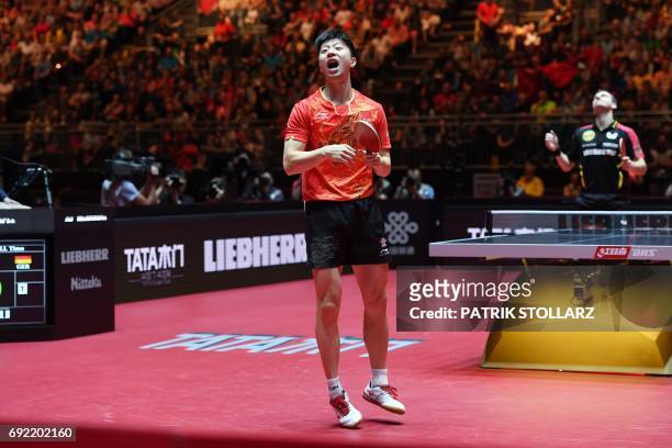 Chinise Ma Long reacts after his plays against German Timo Boll during the quarterfinal match during the WTTC World Table Tennis Championships in...