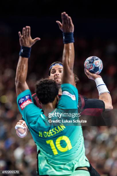 Laszlo Nagy of Veszprem is attacked by Timothey N'Guessan of Barcelona during the VELUX EHF FINAL4 3rd place match between Telekom Veszprem and FC...