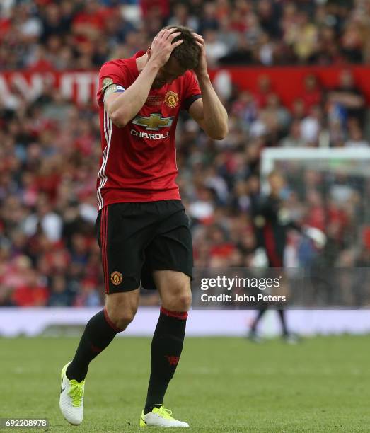 Michael Carrick of Manchester United '08 XI reacts to Gary Neville hitting a wayward shot during the Michael Carrick Testimonial match between...