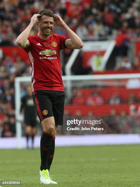 Michael Carrick of Manchester United '08 XI reacts to Gary Neville hitting a wayward shot during the Michael Carrick Testimonial match between...