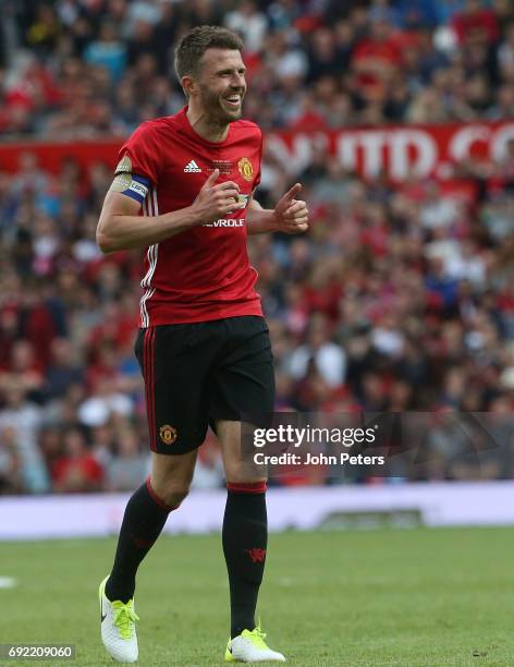 Michael Carrick of Manchester United '08 XI reacts to Gary Neville hitting a wayward shot during the Michael Carrick Testimonial match between...