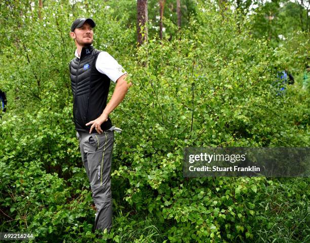 Chris Wood of England looks on after playing into the trees on the 18th hole during day four of the Nordea Masters at Barseback Golf & Country Club...