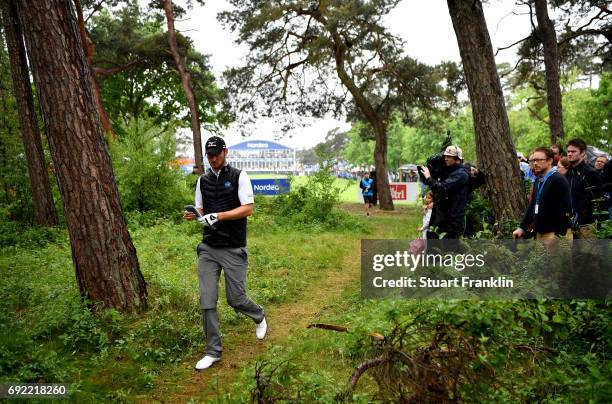 Chris Wood of England attempts to find his ball in the trees on the 18th hole during day four of the Nordea Masters at Barseback Golf & Country Club...