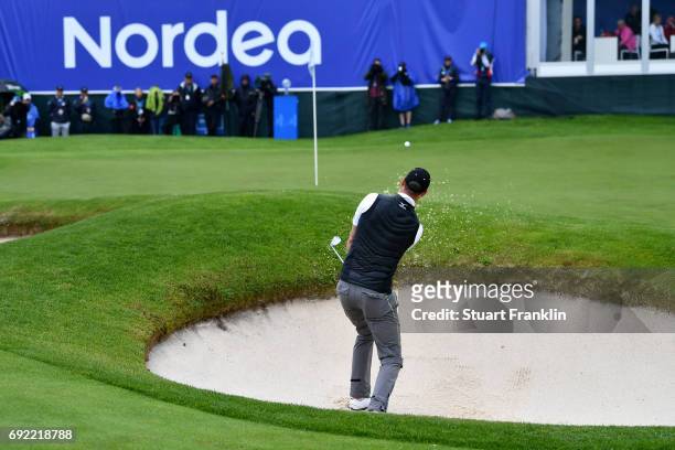 Chris Wood of England plays his fourth shot from a bunker on the 18th whole during day four of the Nordea Masters at Barseback Golf & Country Club on...