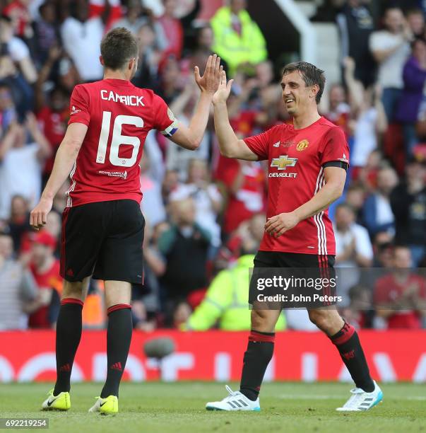 Michael Carrick of Manchester United '08 XI in action with John Terry of Michael Carrick All-Stars during the Michael Carrick Testimonial match...