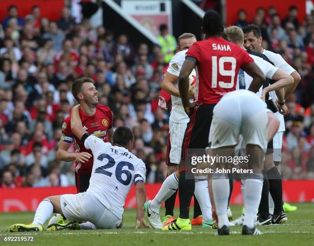 Michael Carrick of Manchester United '08 XI is jokingly bundled over by John Terry and Phil Neville during the Michael Carrick Testimonial match...