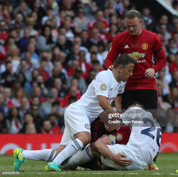 Michael Carrick of Manchester United '08 XI is jokingly bundled over by John Terry and Phil Neville during the Michael Carrick Testimonial match...