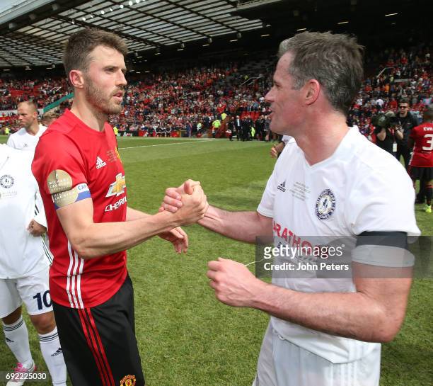 Michael Carrick of Manchester United '08 XI speaks to Jamie Carragher after the Michael Carrick Testimonial match between Manchester United '08 XI...