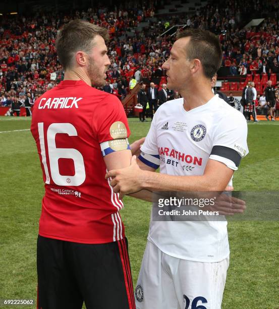 Michael Carrick of Manchester United '08 XI speaks to John Terry after the Michael Carrick Testimonial match between Manchester United '08 XI and...