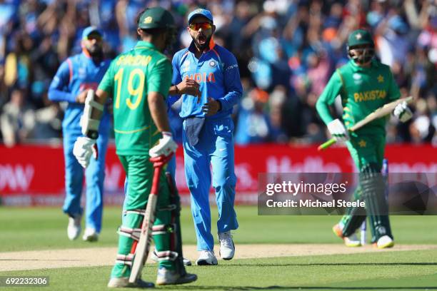 Virat Kohli of India celebrates as Bhuvneshwar Kumar captures the wicket of Ahmed Shehzad of Pakistan during the ICC Champions Trophy match between...