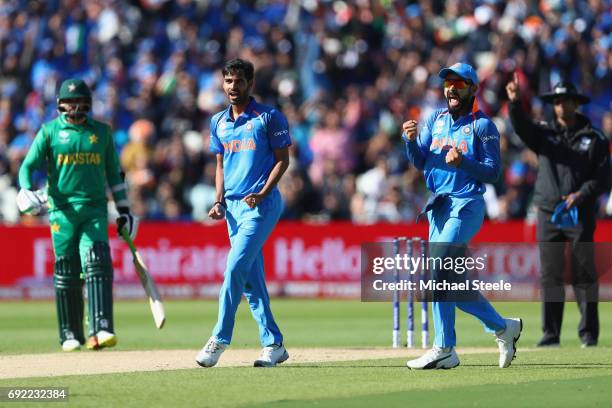Virat Kohli of India celebrates as Bhuvneshwar Kumar captures the wicket of Ahmed Shehzad of Pakistan during the ICC Champions Trophy match between...