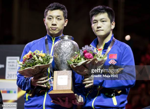 Zhendong Fan of China and Xin Xu of China pose with a trophy during celebration ceremony of Men's Doubles at Table Tennis World Championship at at...