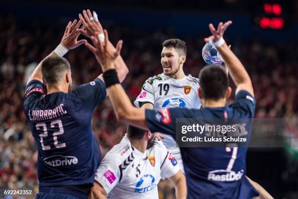 Alex Dujshebaev of Vardar is attacked by Luka Karabatic and Luka Stepancic of Paris during the VELUX EHF FINAL4 Final match between Paris...