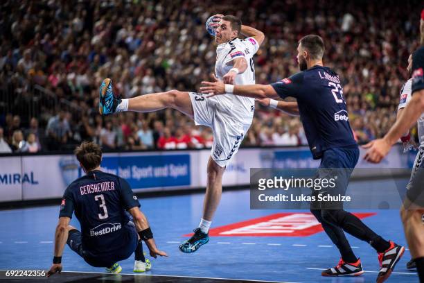 Mijajlo Marsenic of Vardar is attacked by Luka Karabatic of Paris during the VELUX EHF FINAL4 Final match between Paris Saint-Germain Handball and HC...