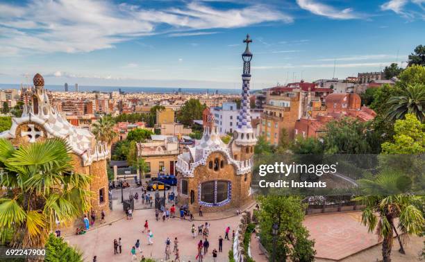 view of park guell and, in the background, the buildings of barcelona. - park guell stock pictures, royalty-free photos & images