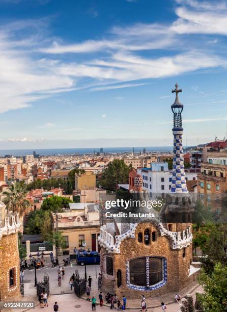 view of park guell and, in the background, the buildings of barcelona. - barcelona gaudi stock pictures, royalty-free photos & images