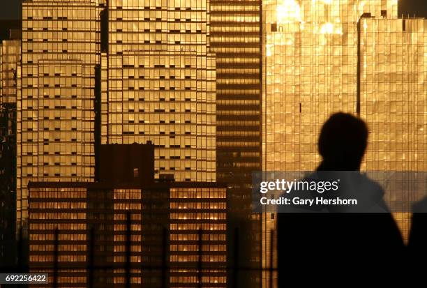 The setting sun reflects off of building along 42nd Street in New York City on June 2 as seen from Weehawken, NJ.