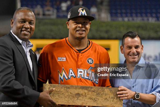 Miami Marlins President of Baseball Operations Michael Hill and President David Samson present Edinson Volquez with the pitching rubber from his no...