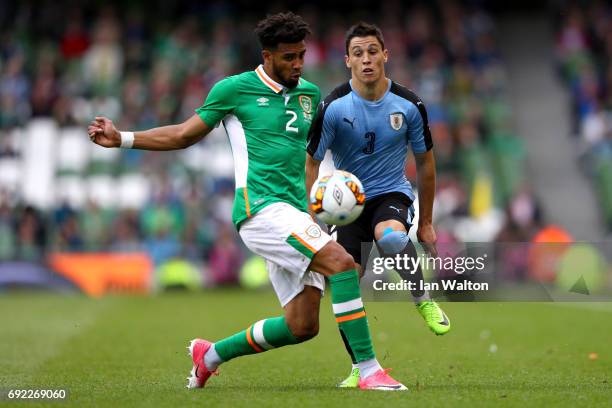 Cyrus Christie of the Republic of Ireland tackles Federico Ricca of Uruguay during the International Friendly match between Republic of Ireland and...