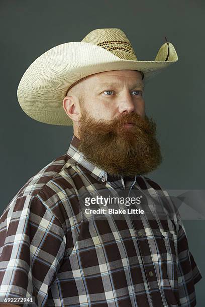 bearded cowboy studio profile - blake green stock pictures, royalty-free photos & images