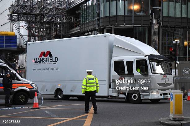 The truck carrying the van used in the attack departs from London Bridge on June 4, 2017 in London, England. Police are investigationg last night's...