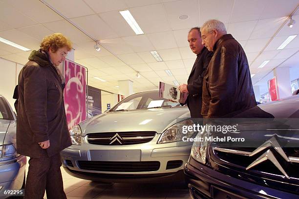 Car salesman talks with customers in a Citroen showroom January 10, 2002 in Leiden, The Netherlands. The European Commisssion has indicated that car...