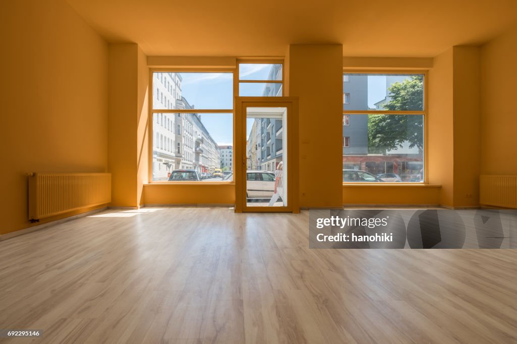 Renovated store / shop - empty room with wooden floor and shopping window