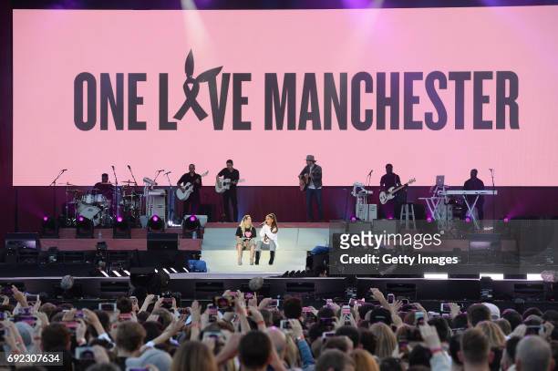 Free for editorial use. In this handout provided by 'One Love Manchester' benefit concert Miley Cyrus and Ariana Grande perform on stage on June 4,...