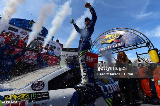 Jimmie Johnson, driver of the Lowe's Chevrolet, celebrates in Victory Lane after winning the Monster Energy NASCAR Cup Series AAA 400 Drive for...