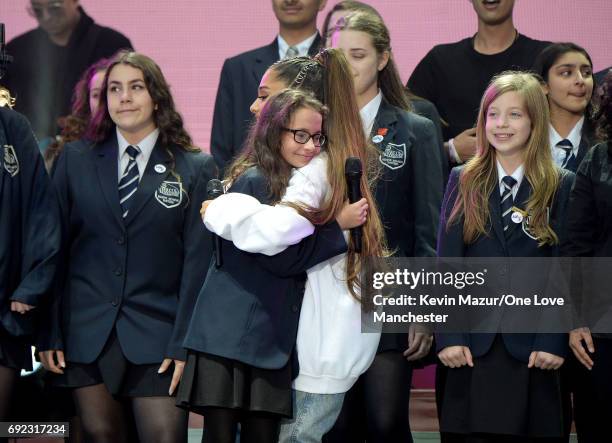 Ariana Grande performs on stage with Parrs Wood High School Choir during the One Love Manchester Benefit Concert at Old Trafford Cricket Ground on...